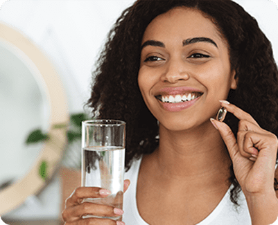 Woman smiling taking medication