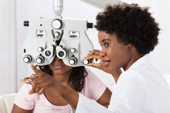Optician doing Comprehensive Eye Exams