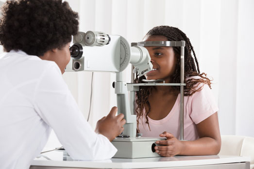 Girl getting a routine eye exam