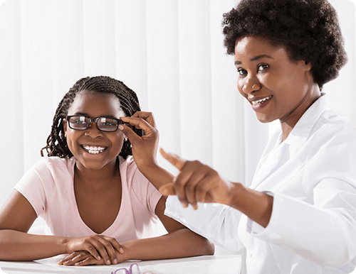 Doctor and little girl trying on glasses