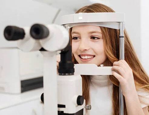 Beautiful girl getting a pediatric eye exam