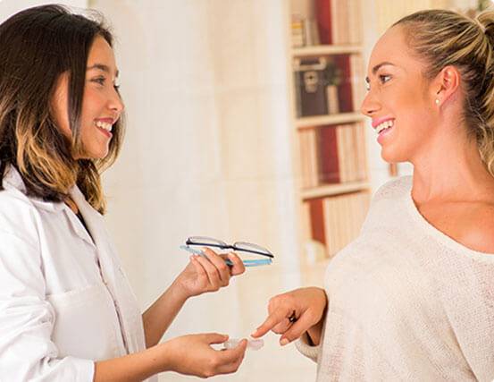 Woman choosing between glasses and contacts