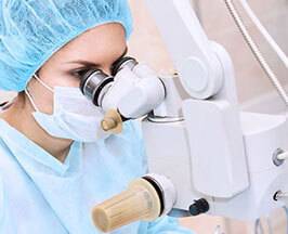 Woman using eye check-up equipment