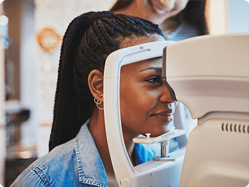 Woman braided hair getting eye exam