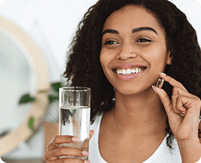 Woman smiling taking medication from Washington Eye Doctors