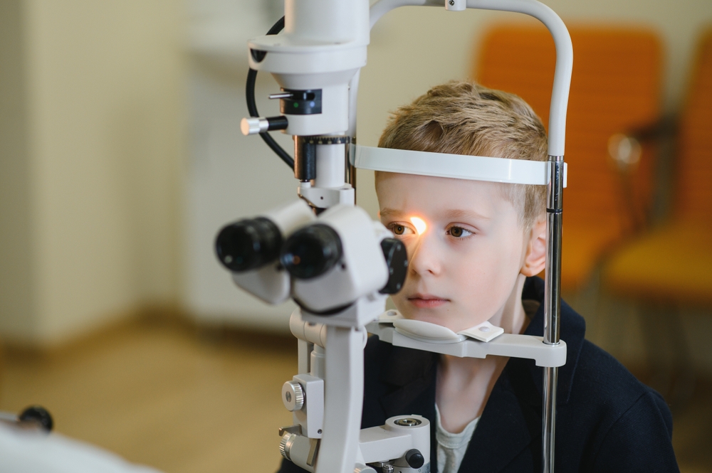 Young,Boy,Undergoing,An,Eye,Examination,With,A,Slit,Lamp Girl getting a routine eye exam